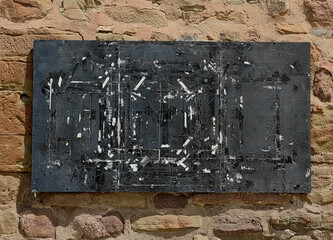 Rustic Elegance. Wooden Blackboard for advertising with Duck Tape White paper  Residue Against Stone Wall background.