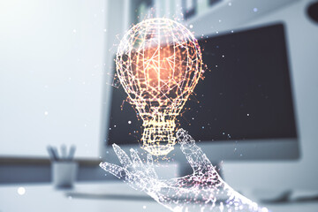 Double exposure of creative light bulb hologram and modern desktop with laptop on background, research and development concept