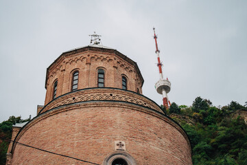 The tower of Mama Daviti church (also known as Mtatsminda Pantheo) and Tbilisi TV tower in Tbilisi (Georgia) - obrazy, fototapety, plakaty