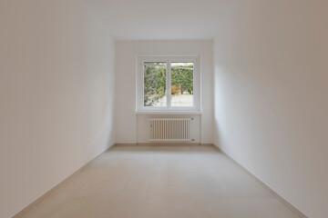 Empty interior of a room, with a central window in the background.