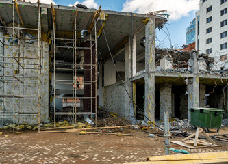 Dismantling of an old building in the city center. The destroyed house is under demolition.