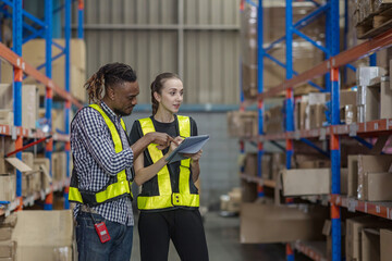 Warehouse worker working in warehouse storage. Foreman or worker work at factory site check up...