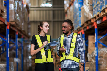 Warehouse worker working in warehouse storage. Foreman or worker work at factory site check up...