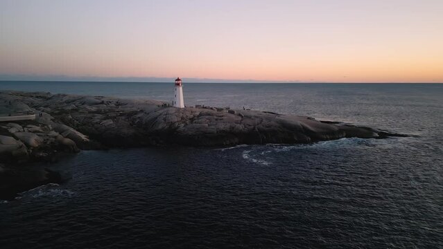 Peggy's Cove Lighthouse at dusk Nova Scotia Canada. As the sky transforms into a canvas soft pastel hues, lighthouse emerges as symbol resilience and hope, guiding sailors home with its steadfast glow