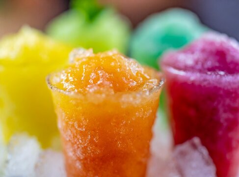Frozen Rainbow Slush Drinks Chilling on Ice served at the bar of a dinning room