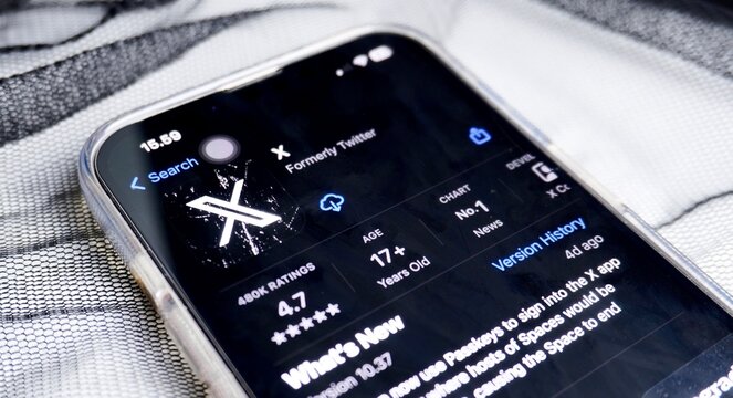 Jakarta, Indonesia - April 22th, 2024 - Close up X app formerly known as Twitter on app store. Mobile application on Iphone 13 smartphone body isolated on transparent thin black fabric background.