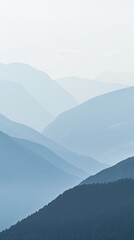 Fototapeta premium Serene Blue Mountain Range Fading into Misty Sky