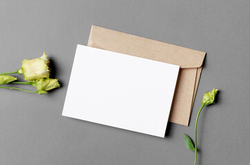Wedding invitation card mockup with envelope and flower, top view with copy space