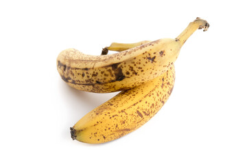 Two very ripe and spotted yellow and brown bananas on a white background