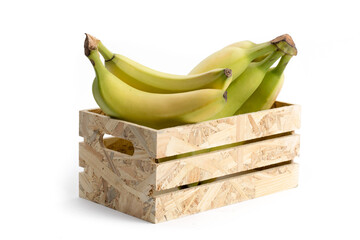 a bunch of natural looking ripe yellow  bananas in a wooden crate isolated on white