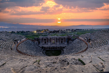 Amphitheater in ancient city of Hierapolis. Dramatic sunset sky. Unesco Cultural Heritage Monument....