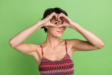 Photo of lovely girlfriend wear summer clothes show heart figure isolated on green color background
