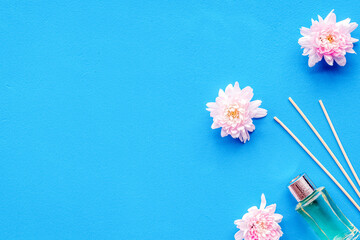 air freshener sticks with flowers on blue background top view mockup