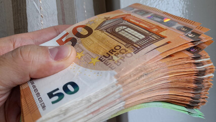 Banconote da 50 euro nelle mani di un uomo - ricchezza - obrazy, fototapety, plakaty