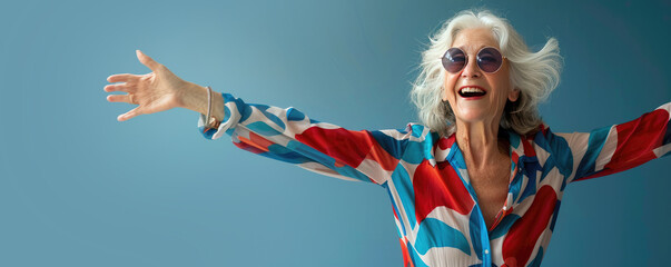 Happy Mature Dancing Woman Dressed in Red white and Blue for the 4th of July on a Blue Background with Space for Copy