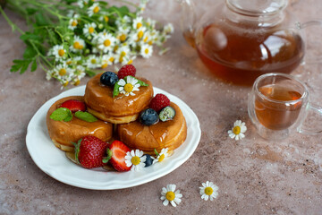 Breakfast pancakes with berries and chamomile tea. 