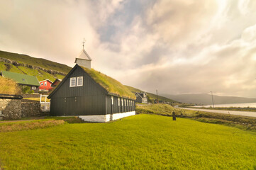 Typical Faroese wooden church standing close to the coast in Kollafjørður.  