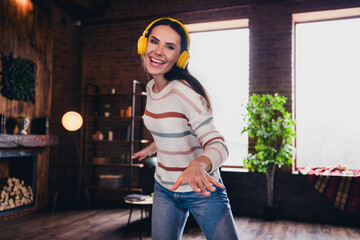 Photo of lovely young woman dancing listen music headphones wear striped outfit interior home living room in brown warm color
