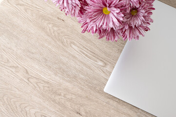 Aesthetic minimalist background for business branding, gray laptop and pink daisy flowers bouquet...