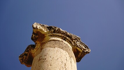 low angle of stone column against sky