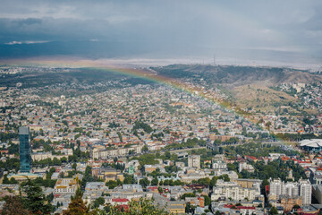 View on the city of Tbilisi after the rain, with a beautiful rainbown from Mtatsminda Park (Georgia)