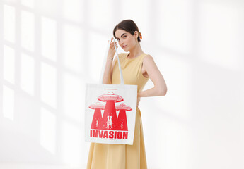 Mockup of woman carrying customized tote bag in studio