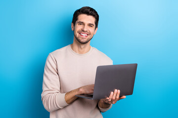 Photo of young nice man use wireless laptop coworking wear beige sweatshirt isolated on blue color background - 791897709
