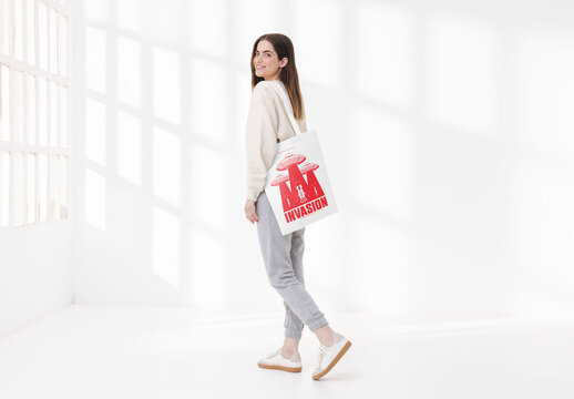 Mockup of woman holding customized tote bag on shoulder