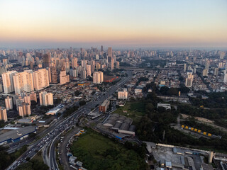 Fototapeta na wymiar Incredible sunset in the city of São Paulo, a megalopolis with an aerial image above the Tietê River.