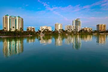 Sarasota skyline with tranquil waters reflecting buildings during evening hours, Florida, United...