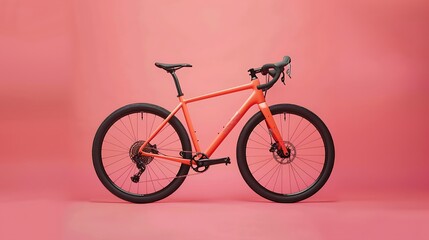 Fototapeta premium Gravel bicycle orange bike for cross country cycling on pink background