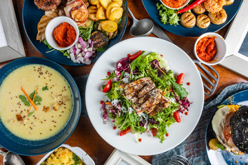 Table full of food: A bountiful spread of various dishes and delicacies, offering a feast for the senses and a delightful culinary experience.