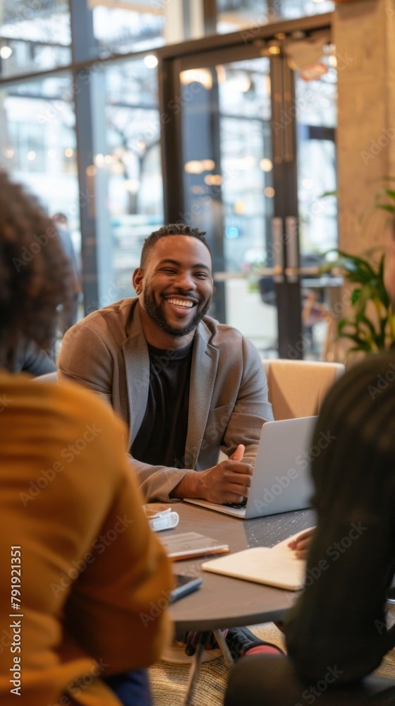 Aufkleber a man is smiling and sitting at a table with a laptop