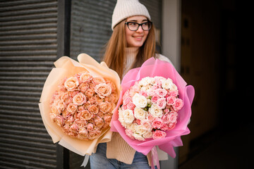 Two bouquets of pastel roses in hands of charming smiling girl - 791928311