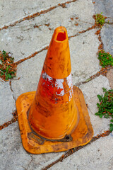 Weathered Orange Traffic Cone Symbol of Road Wear and Tear