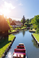 Scenic view of green riverside garden house german national park Spreewald on spring summer sunny day . Spree river forest greenery canal nature tranquil landscape in Germany blue sky background