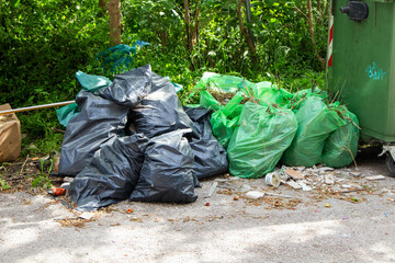 Green and Black Trash Bag Piles: Waste Management Scene