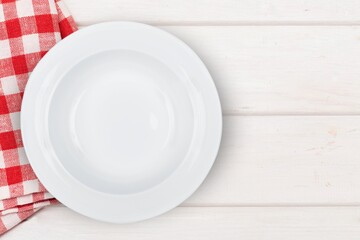empty round plate on colored tablecloth for food.