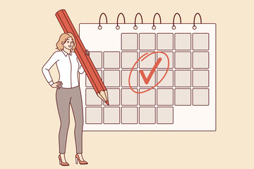 Woman is engaged in business planning and uses calendar to keep schedule, standing with large pencil in hand. Businesswoman making planning to increase productivity and avoid missing deadlines