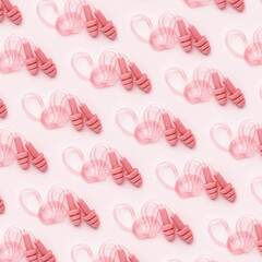 Pink color earplugs, for swim, sleep, rest as minimal trend pattern on pink background, monochrome...
