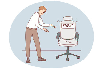 Smiling employer point at vacant chair