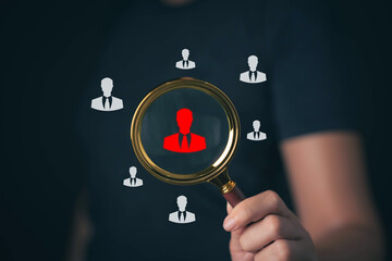 HRM or Human Resource Management,  leadership and customer target group concept.Magnifier glass focus to manager icon which is among staff icons for human development recruitment.