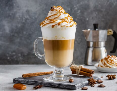 Latte macchiato with whipped cream and caramel cream on top in a glass