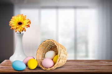 Wooden table with easter eggs , flowers