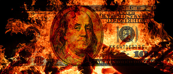 100  US dollar banknote in flame