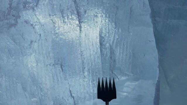 slow motion. a man makes a product out of ice. A man cleans the ice. a man chops off a piece of ice.The guy is making something out of ice. a trip to Lake Baikal