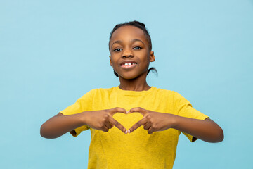 Smiling African American little boy making heart shape gesture - 791950983
