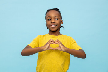 Satisfied dark- skinned little boy making heart with hands - 791951150