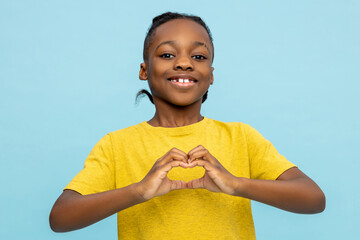Friendly African American little boy showing heart made with hands
