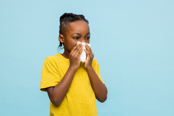 Unhealthy African American little boy suffering flu symptoms